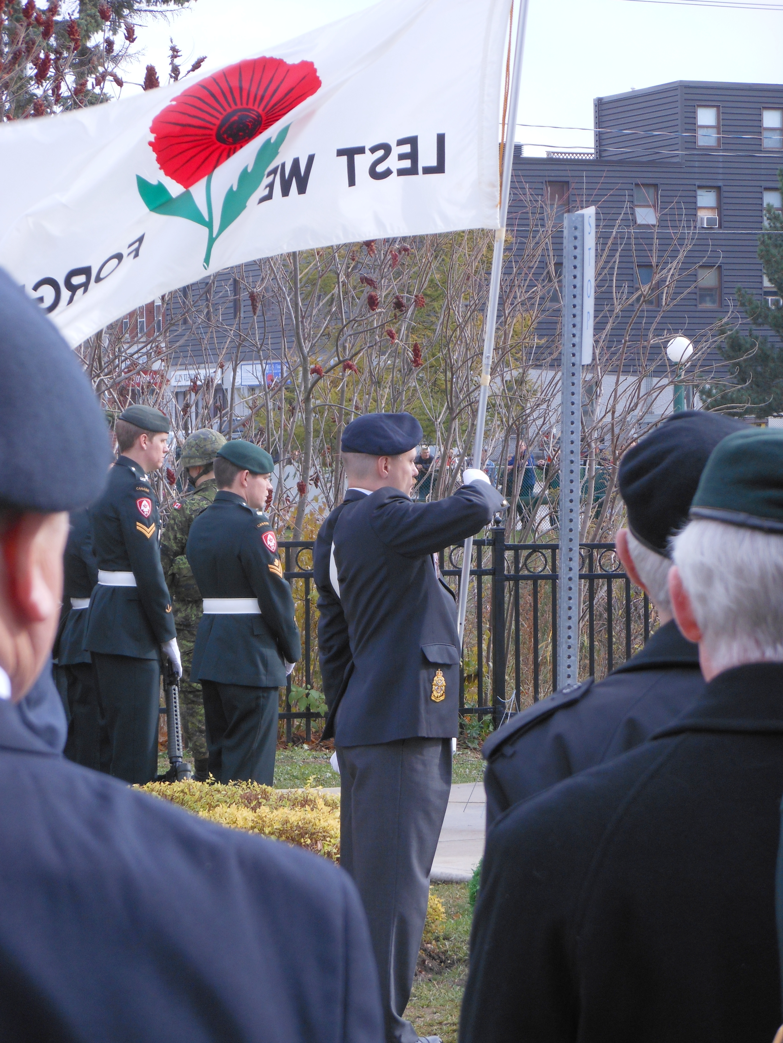 Capt Steven Dieter, CD (Ret'd) carrying Poppy Flag.